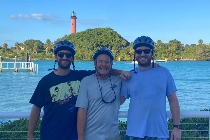 a group of people standing next to a body of water