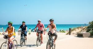 a group of people riding on the back of a bicycle
