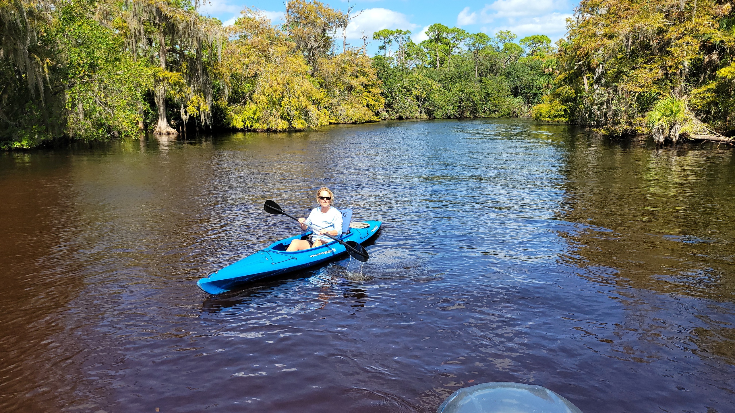 a group of people riding on the back of a boat in the water