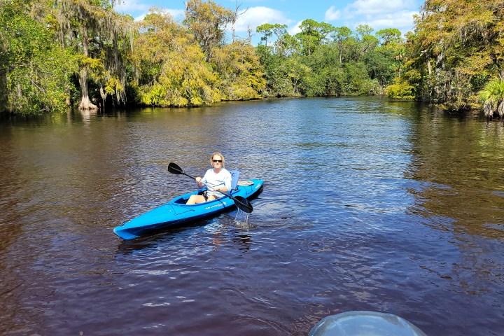 a group of people riding on the back of a boat in the water