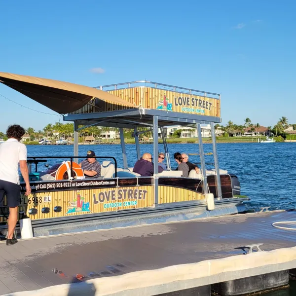 a person sitting on a dock next to a body of water