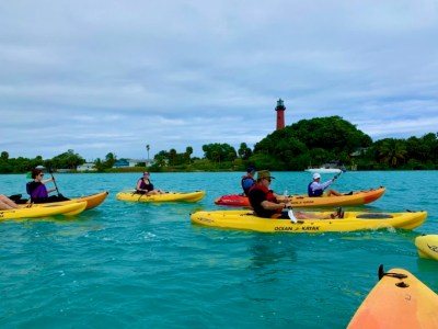 a group of people riding on the back of a boat in the water